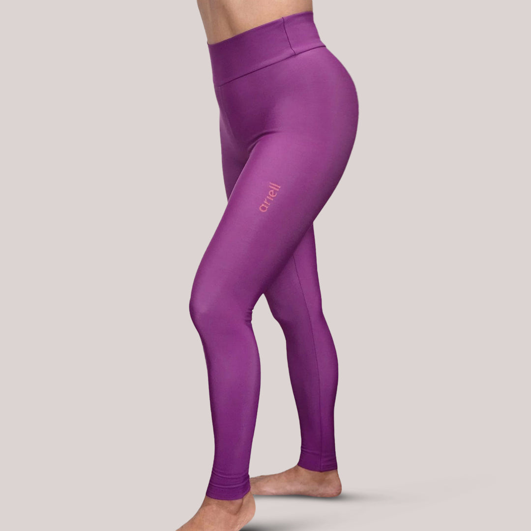 Purple leggings with a brand logo on a light gray background